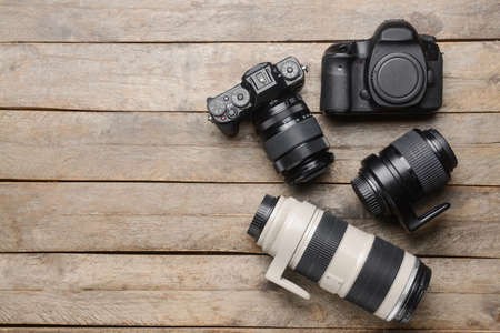Digital cameras and lenses on wooden backgroundの写真素材