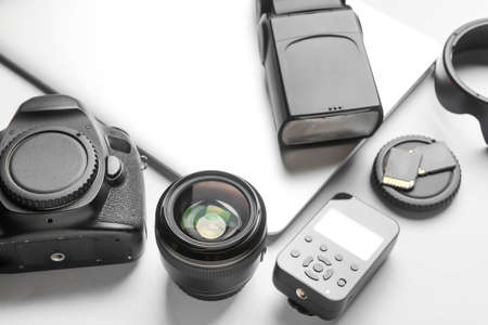 Modern photographer's equipment and laptop on light background, closeupの写真素材