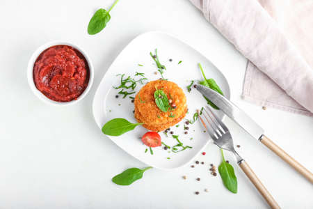 Plate with tasty lentil cutlets on light background