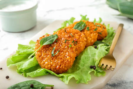 Board with tasty lentil cutlets on tableの写真素材