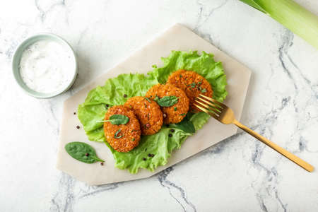 Board with tasty lentil cutlets on white backgroundの写真素材