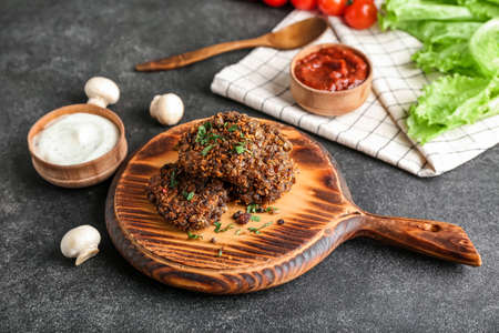 Board with tasty lentil cutlets on dark backgroundの写真素材