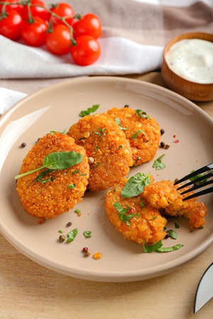 Plate with tasty lentil cutlets on table