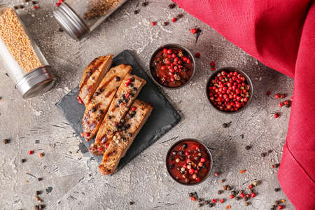 Tasty roasted meat and peppercorn sauce on grunge backgroundの写真素材