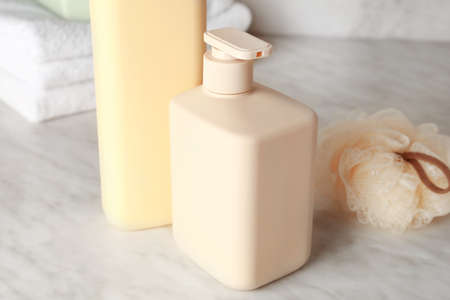 Bottles of shower gel, sponge and towels on light background, closeupの写真素材