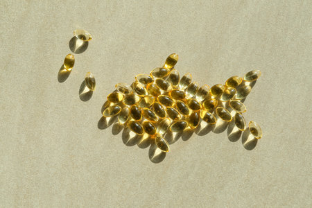 Fish made of oil capsules on gray backgroundの写真素材