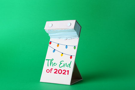 Tear-off calendar at the end of the year 2021 on color backgroundの写真素材