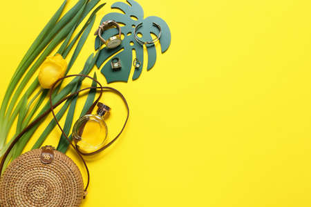 Stylish female accessories with tulip flower on color backgroundの写真素材