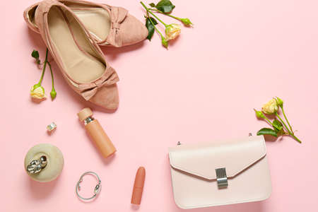 Stylish female accessories with flowers on color backgroundの写真素材