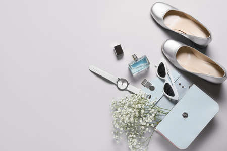 Stylish female accessories with flowers on gray backgroundの写真素材