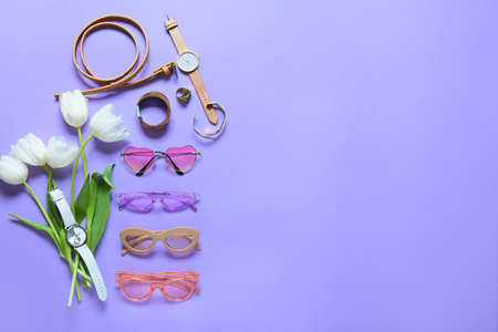Stylish female accessories with flowers on color backgroundの写真素材