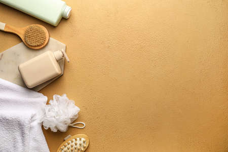 Bottles of shower gel and bath supplies on color background