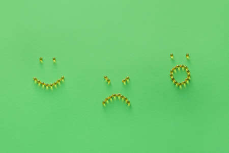 Faces made of pills on color backgroundの写真素材