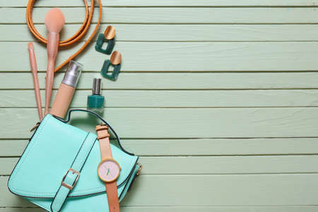Set of female accessories and cosmetics on color wooden backgroundの写真素材