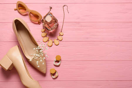 Set of female accessories with stylish shoes on color wooden backgroundの写真素材