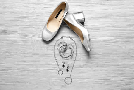 Stylish female accessories and shoes on gray wooden backgroundの写真素材