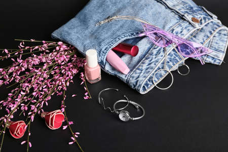 Set of female accessories, clothes and flowers on dark backgroundの写真素材