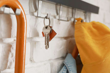 Rack with key hanging on brick wall, closeupの写真素材