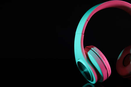 Modern headphones on dark background, closeupの写真素材