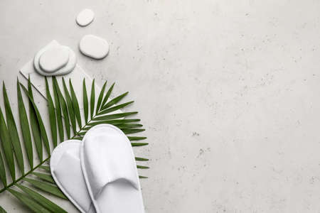 Spa stones with slippers on gray backgroundの写真素材