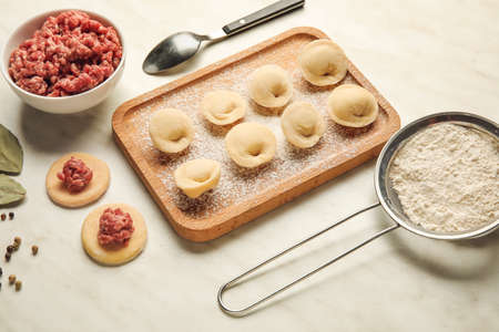 Composition with raw dumplings and ingredients on light backgroundの写真素材