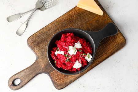 Frying pan with tasty beet risotto on light backgroundの写真素材