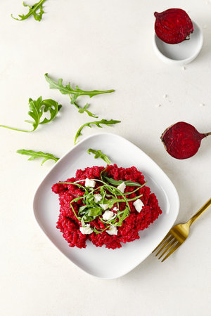 Plate with tasty beet risotto on light backgroundの写真素材