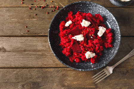 Plate with tasty beet risotto on wooden backgroundの写真素材