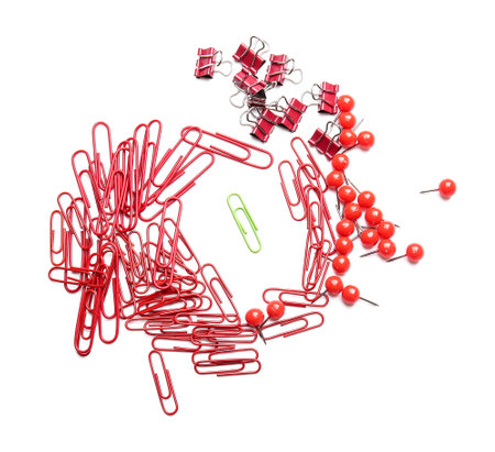 Green paper clip among red ones on white background. Concept of uniquenessの写真素材