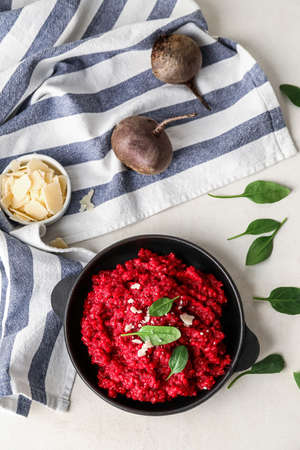 Frying pan with tasty beet risotto on light backgroundの写真素材