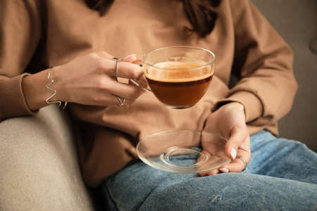 Woman drinking tasty coffee, closeup