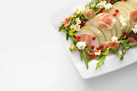 Plate with tasty popcorn salad on white backgroundの写真素材