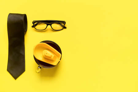 Male necktie with eyeglasses, cup of coffee and boat toy on color background. Concept of vacationの写真素材