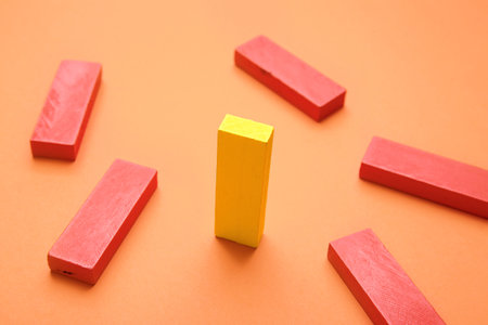 Yellow block among red ones on color background. Concept of uniquenessの写真素材