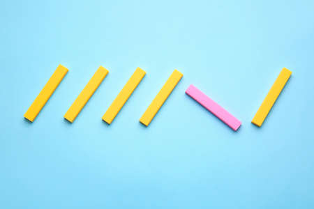 Pink eraser among yellow ones on color background. Concept of uniquenessの写真素材