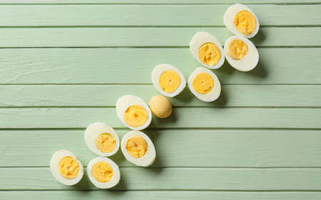 Boiled eggs on color wooden background. Concept of uniquenessの写真素材