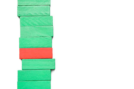 Red block among green ones on white background. Concept of uniquenessの写真素材