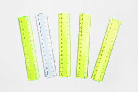 Transparent ruler among yellow ones on light background. Concept of uniquenessの写真素材