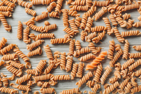 Italian pasta on wooden background. Concept of uniqueness