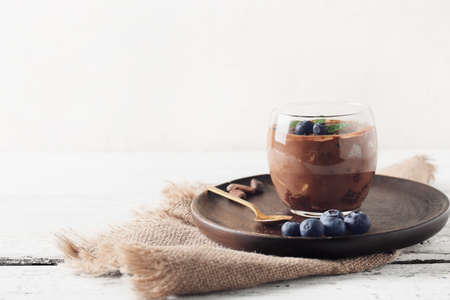 Glass of sweet cocoa dessert on tableの写真素材
