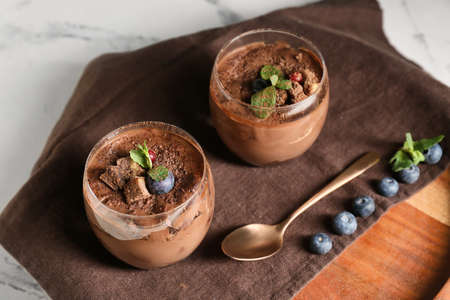 Glasses of sweet cocoa dessert on stand