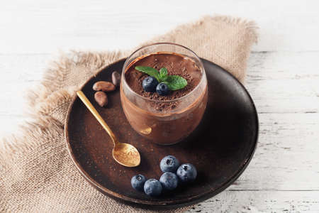 Glass of sweet cocoa dessert on tableの写真素材