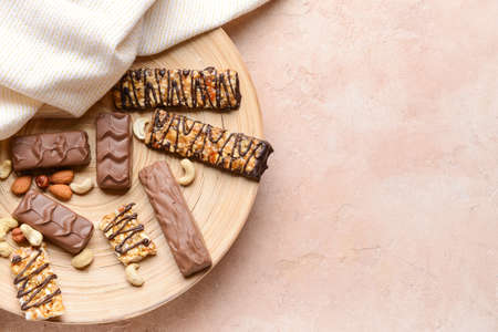 Tray with tasty chocolate nut bars on grunge background