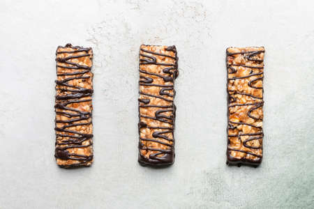 Tasty chocolate nut bars on grunge backgroundの写真素材