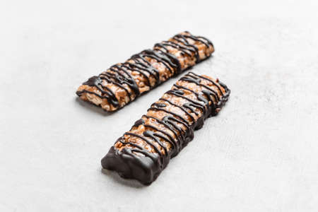 Tasty chocolate nut bars on grunge background