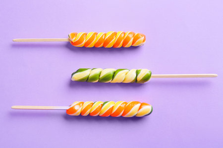 Sweet lollipops on color background. concept of uniqueness