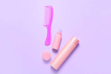 Hair comb and cosmetics on color backgroundの写真素材