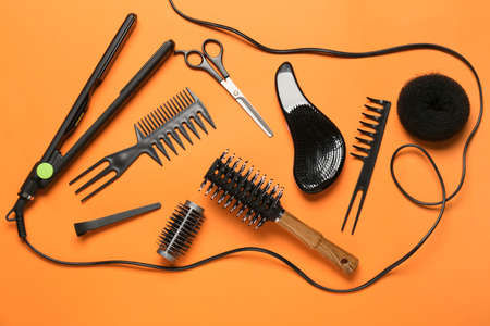 Set of hairdresser's tools on color background