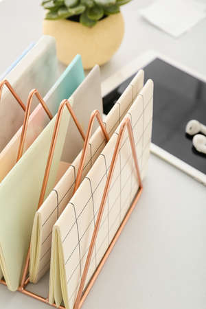 Stand with notebooks on light background, closeupの写真素材