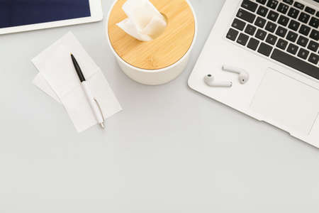 Modern devices with stationery and tissue box on light backgroundの写真素材